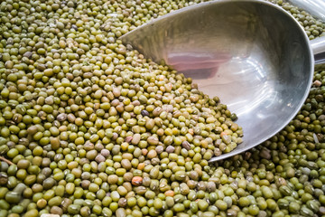 Obraz premium Pile of organic green mung beans with scooper