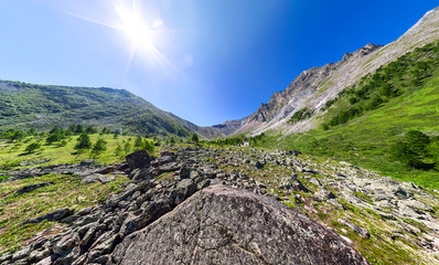 Wide aerial panorama river stone and mountain peaks