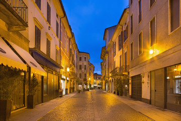 CREMONA, ITALY - MAY 24, 2016: The street of old town in morning dusk.
