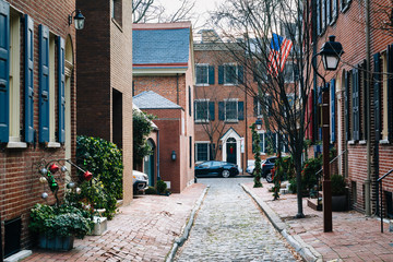 Historic brick houses and narrow cobblestone alley in Society Hi