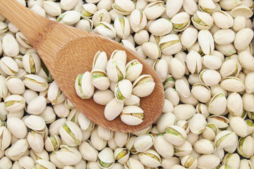 Pistachio nuts with wooden spoon