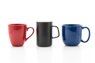Set of black, red and blue cups on white