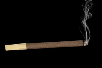 Lit cigar isolated on black