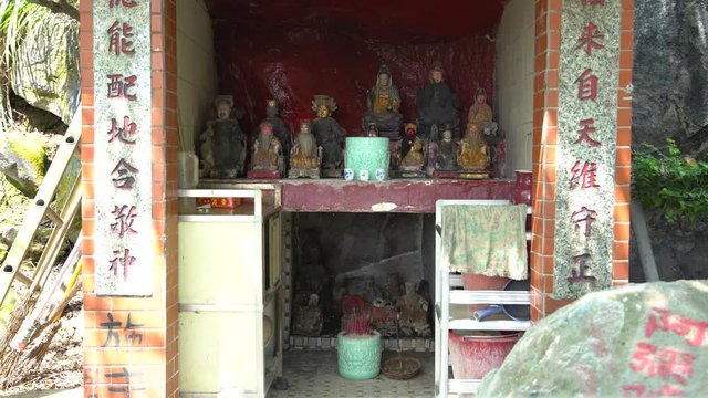 4K Small and ancient Buddhist temple with Sacred Statue, different figures of gods on shrine inside. Locate at the midle of the mountain Yang Ming Shan. Shot in Taipei, Taiwan. -Dan