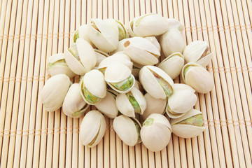 Pistachio nuts on bamboo background