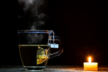 A tea of glass and a candle
