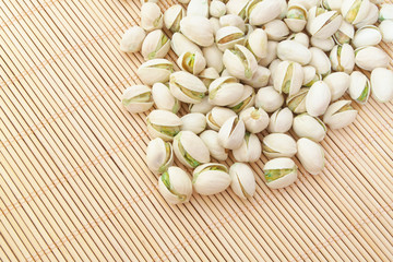 Pistachio nuts on bamboo background