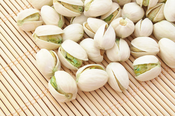 Pistachio nuts on bamboo background