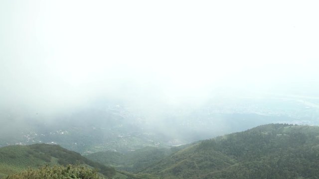 4K Aerial view of Taipei city in a cloudy day with fog from the Beitou Mountain in Yang Ming Shan, Taiwan-Dan