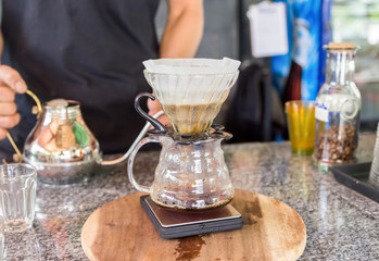 barista dripping coffee with filter  in coffee shop