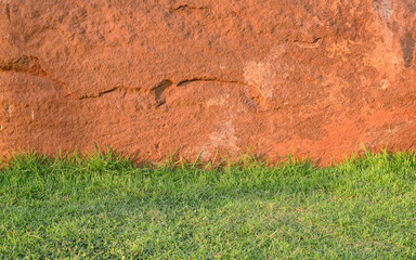Sandstone wall and green grass