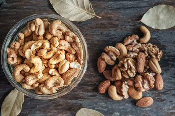 Cashew nuts, Walnuts and almonds wooden background.