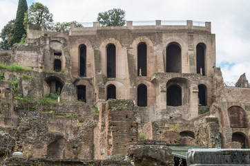 The Roman Forum is a plaza surrounded by many ruins of ancient government buildings in the center of Rome