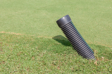 The black plastic pipe tip under the meadow in golf course for w