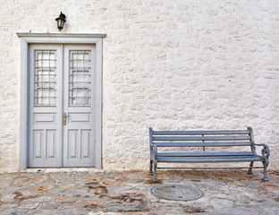 Greece, vintage wooden door and bench