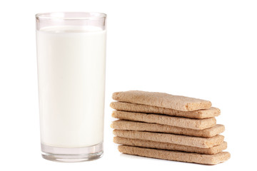 glass of milk with stack of grain crispbreads isolated on white background