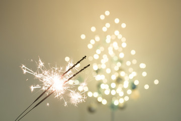 Festive sparklers in front of tree light bokeh 