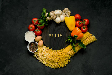 Obraz na płótnie Canvas Ingredients for pasta on a black background.
