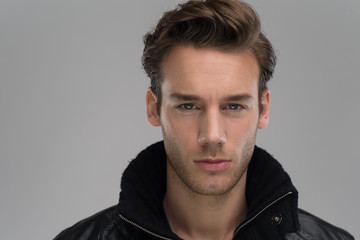 portrait of a young guy over gray background