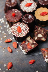 Assorted chocolates candies with nuts and goji berries
