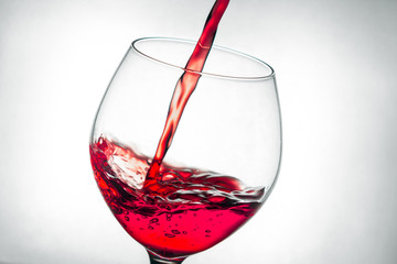 red wine pouring splash into glass