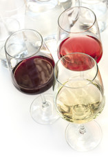 Three glasses of wine on white background with copyspace