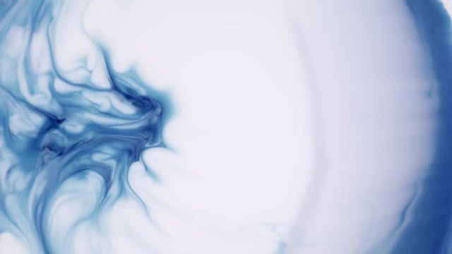 Milk ink and soap mixing to create swirling patterns