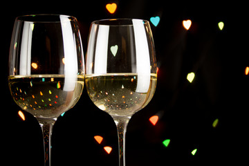 wine glass on hearts bokeh background, concept of valentine's day