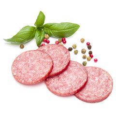 Salami smoked sausage slices, basil leaves and peppercorns isola