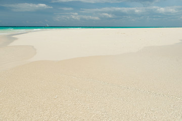 sandy beach and clear transparent sea wave