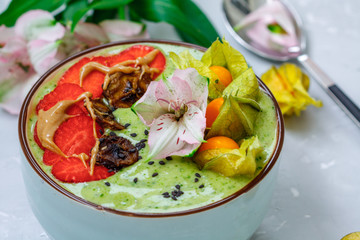Green banana smoothie bowl with berries. Clean eating, vegetarian, raw, detox, dieting concept