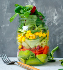 Healthy take-away lunch jar with salmon, cucumber and avocado. Love for a healthy food concept