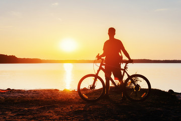 Fototapeta premium boy on a bicycle at sunset