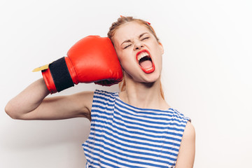 impulsive woman in boxing gloves beats herself in the face