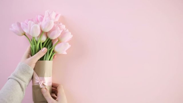 Bouquet of pink tulips on a pink background