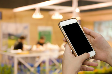 Young woman using mobile smartphone at coffee shop