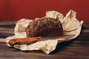 rye bread on wrapping paper with a knife