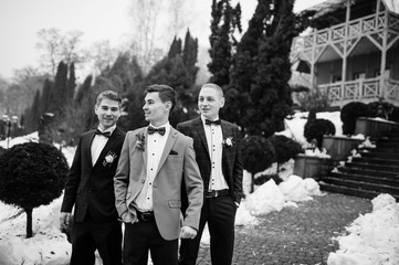 Groom with best mans at winter wedding day. Black and white phot