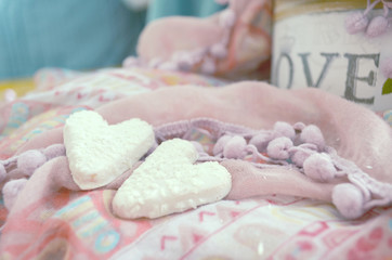 Obraz na płótnie Canvas Cookies in the shape of hearts on the textiles background. Boho style. Love concept background. February 14 Holidays. Happy valentines day celebration