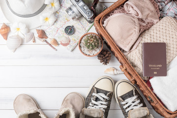 Travel accessories costumes on white wood background