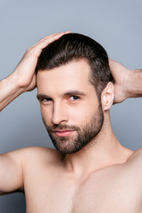 Portrait of healthy man combing his hair with fingers