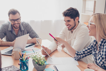 Three happy colleagues planning strategy of future work