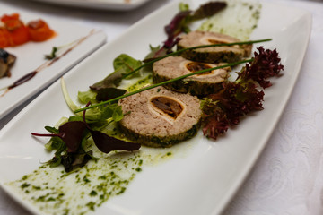 gefilte fish on white plates buffet table