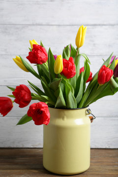 Bright tulips in metal vase