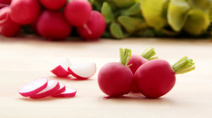 Radish. Slices and pieces of radishes. Wooden background. Closeup view.