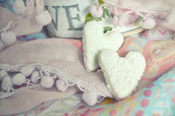 Cookies in the shape of hearts on the textiles background. Boho style. Love concept background. February 14 Holidays. Happy valentines day celebration