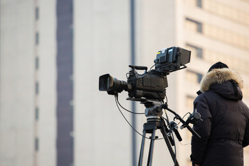 Operator with the TV camera on the roof of the building