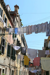 Obraz na płótnie Canvas Venice Italy so clothes hanging in the street called Calle in it