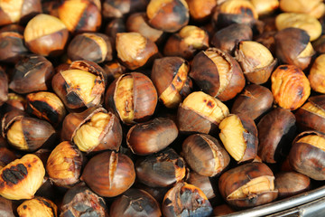 many cooked chestnuts for sale in the stall in the street