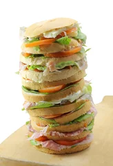Foto op Plexiglas anti-reflex big sandwich with cheese ham tomato on a cutting board and white © ChiccoDodiFC